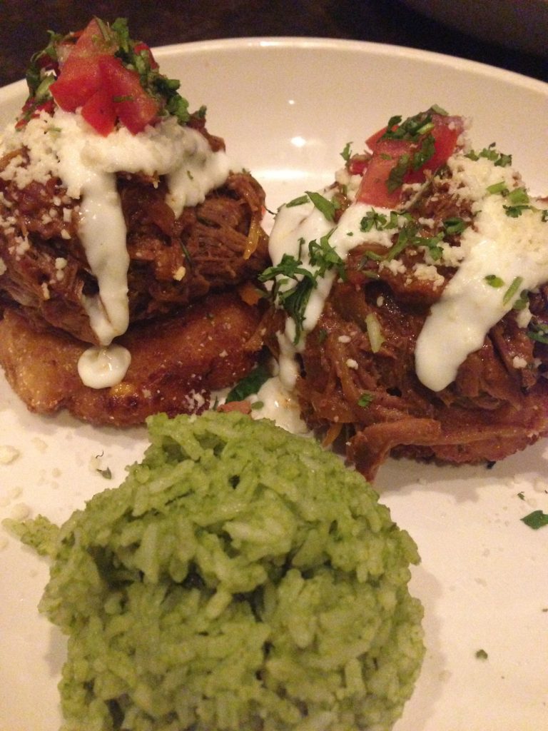 Delicia's Tamal Corn Cakes topped with Barbacoa Beef